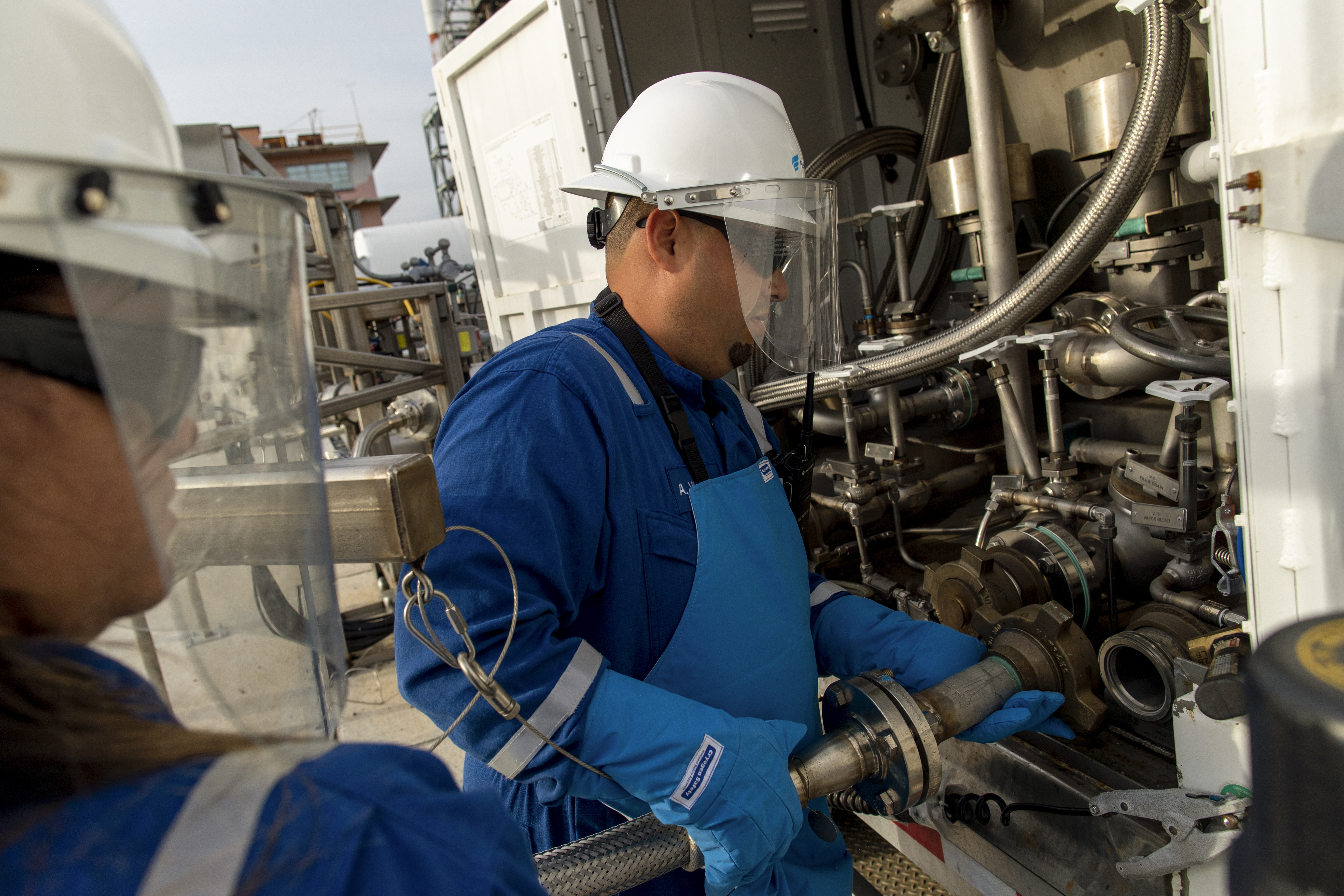 NFE employee standing on LNG plant 