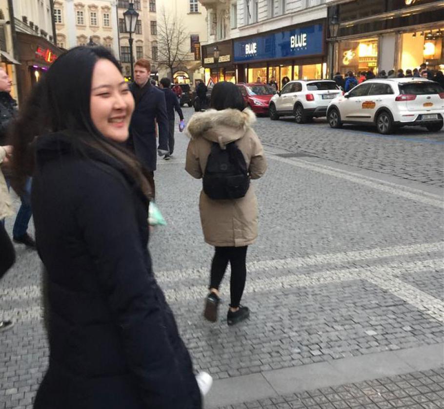 NFE employee walking down a street smiling 