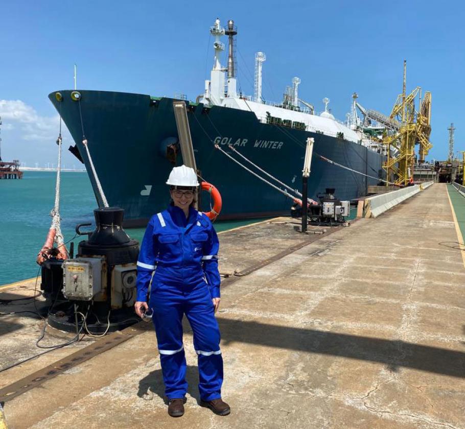 NFE employee standing in front of ship