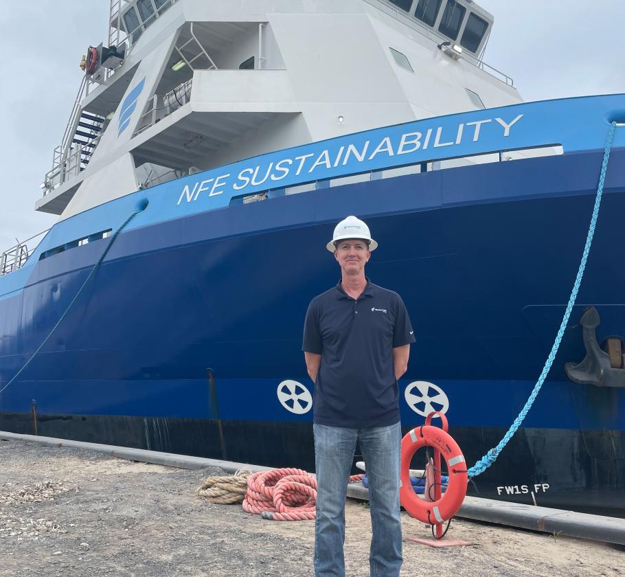 NFE employee standing by a ship