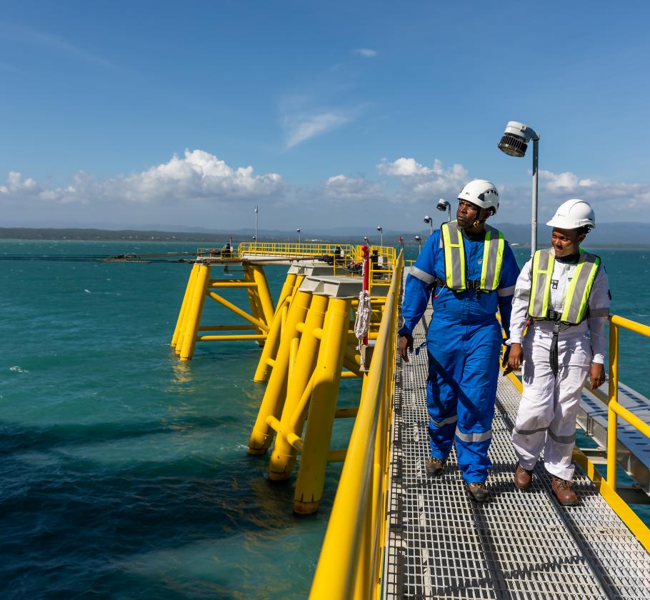 Employees walking around offshore LNG facility